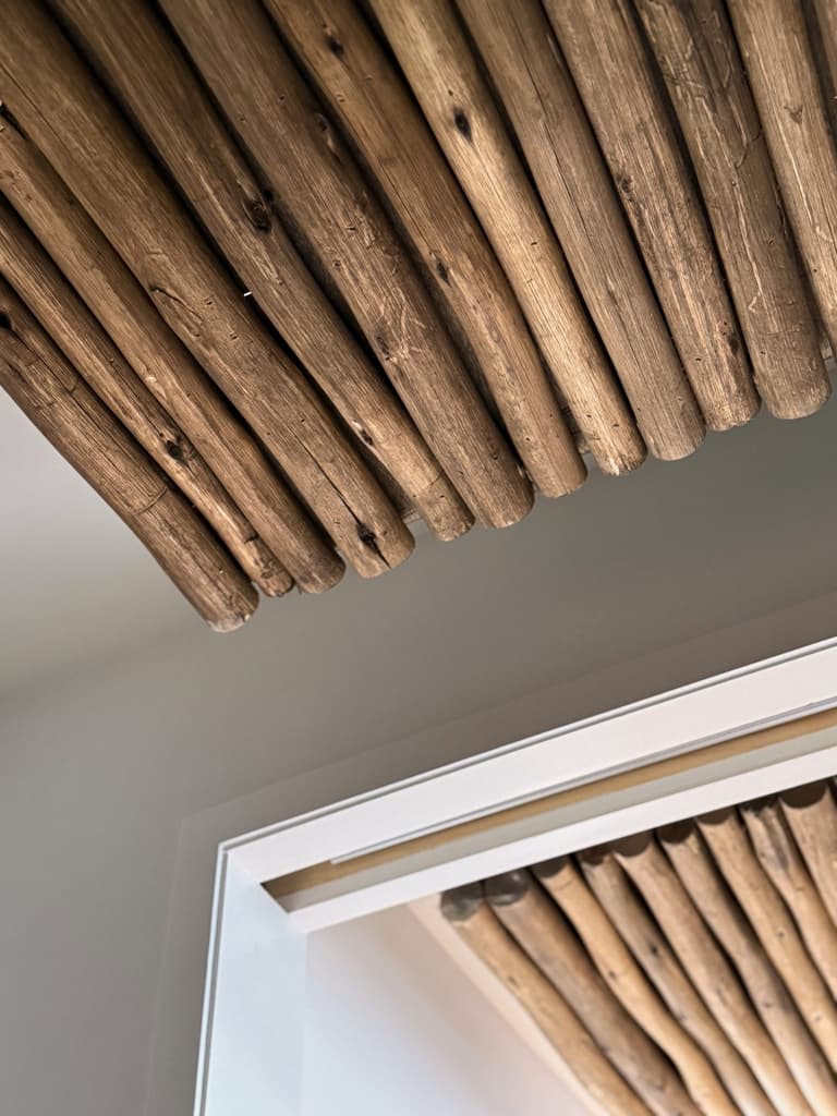 Eucalyptus pole ceiling running over a doorway in a Westfield, NJ pool cabana by Michael Robert Construction