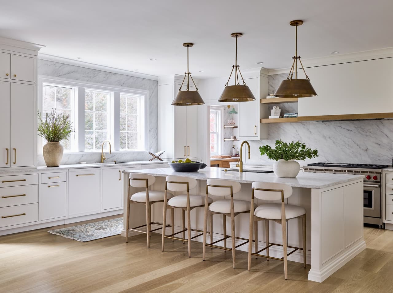 Completed Summit kitchen with a marble island and brass pendant lights.