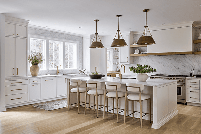 Neutral kitchen with a marble backsplash and brass fixtures in a whole-home renovation in Summit, NJ, by Michael Robert Construction